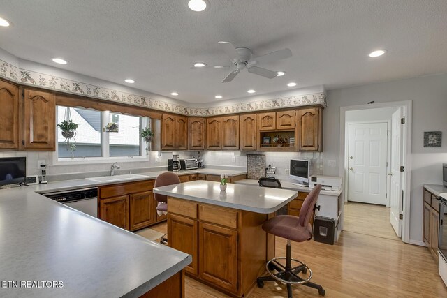 212 Tooweka Ln, Loudon, TN 37774 - kitchen featuring a ceiling fan, brown cabinets, tasteful backsplash, recessed lighting, and a textured ceiling