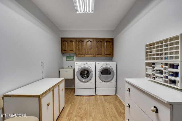 212 Tooweka Ln, Loudon, TN 37774 - laundry room with separate washer and dryer, cabinet space, and light wood-type flooring