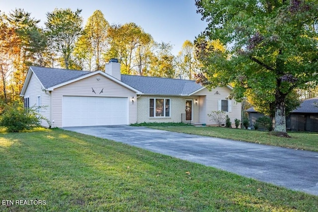 single story home with driveway, a chimney, an attached garage, and a front lawn