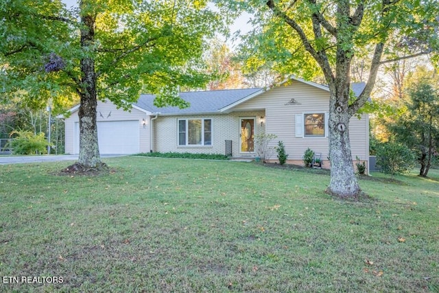 ranch-style home featuring a front lawn, a garage, and concrete driveway