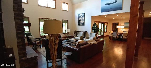 living room featuring wood finished floors and a towering ceiling