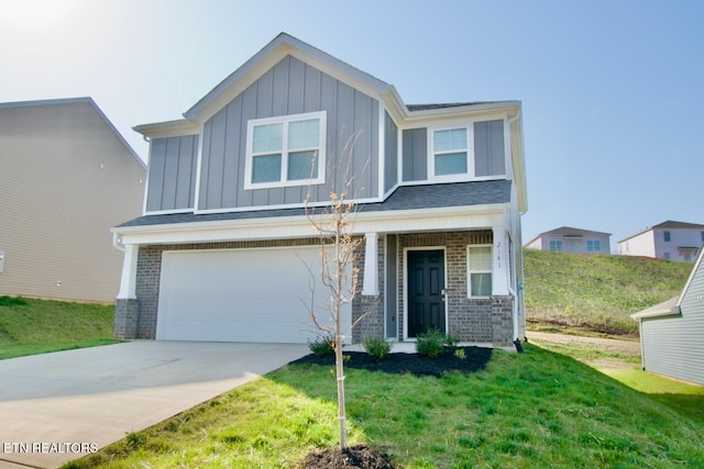2141 Glen Crk, Knoxville, TN 37924 - view of front of home with concrete driveway, board and batten siding, an attached garage, a front yard, and brick siding