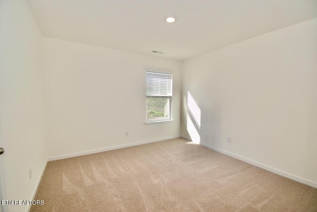 2141 Glen Crk, Knoxville, TN 37924 - unfurnished room featuring visible vents, baseboards, and light carpet