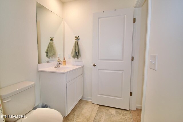 2141 Glen Crk, Knoxville, TN 37924 - bathroom featuring vanity, baseboards, and toilet