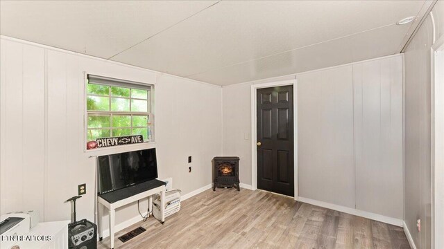 419 Mountain Thrush Dr, Townsend, TN 37882 - unfurnished living room featuring a wood stove, light wood-style flooring, and baseboards