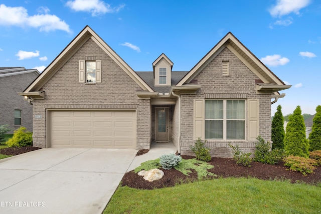 traditional-style home featuring a garage, concrete driveway, and brick siding