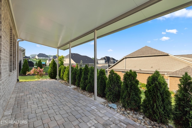 view of patio / terrace with fence and a residential view