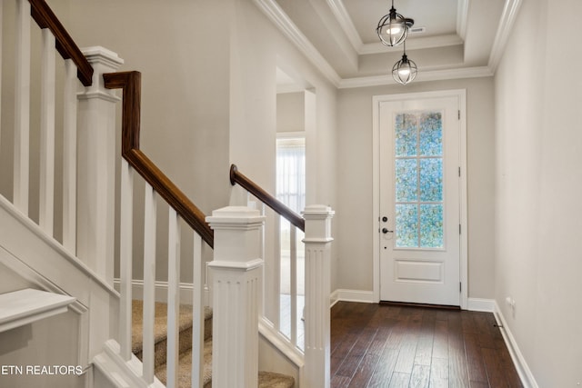 entryway with crown molding, dark wood-style flooring, baseboards, a tray ceiling, and stairway