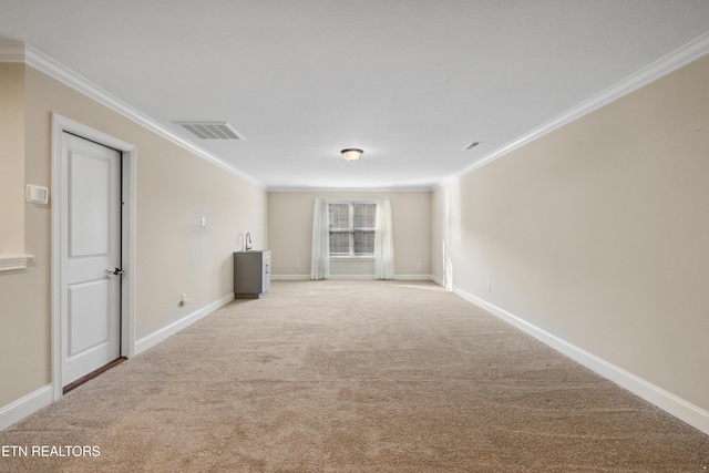unfurnished room with baseboards, visible vents, ornamental molding, and carpet
