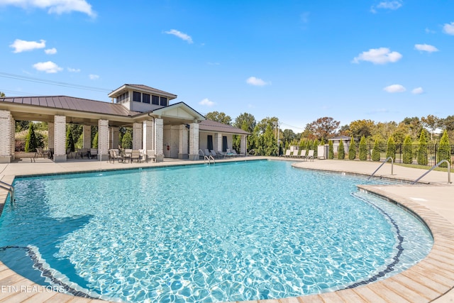 pool with fence and a patio area