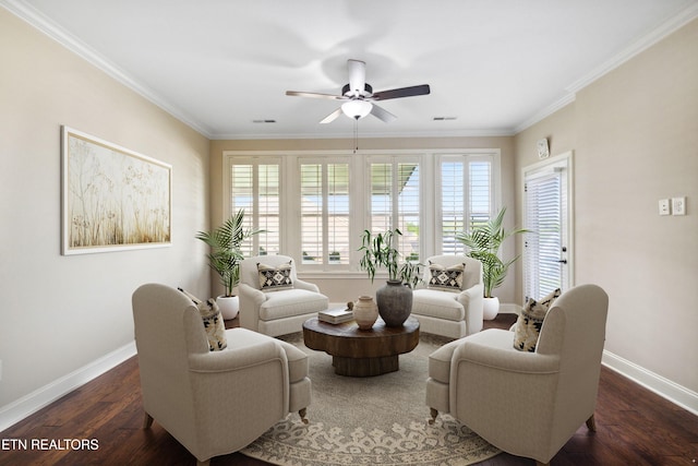 living area featuring a healthy amount of sunlight, baseboards, ornamental molding, and a ceiling fan