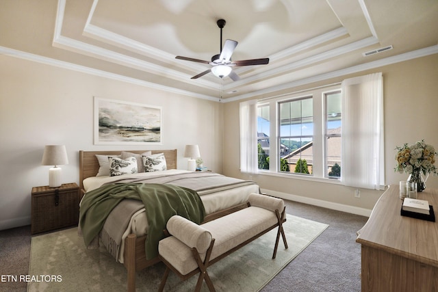 bedroom with visible vents, carpet floors, baseboards, ornamental molding, and a tray ceiling