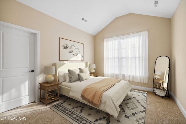 bedroom featuring visible vents, baseboards, lofted ceiling, and carpet