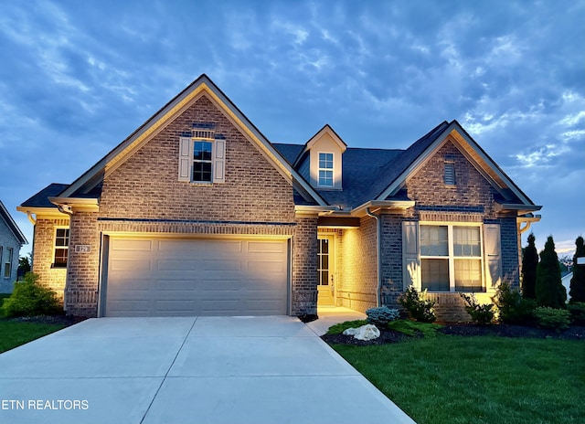 129 Reverence Run Ln, Knoxville, TN 37934 - view of front of home featuring brick siding, driveway, and a front lawn