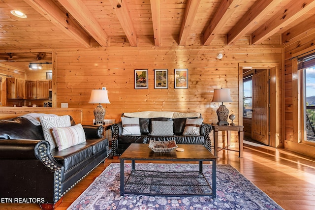 living area featuring wood ceiling, wood-type flooring, and beam ceiling