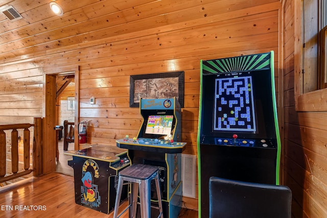bar with wood walls, wood finished floors, and visible vents