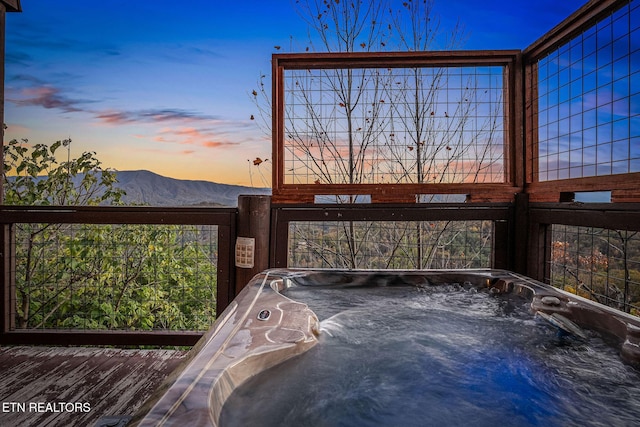 details with a jacuzzi and a mountain view