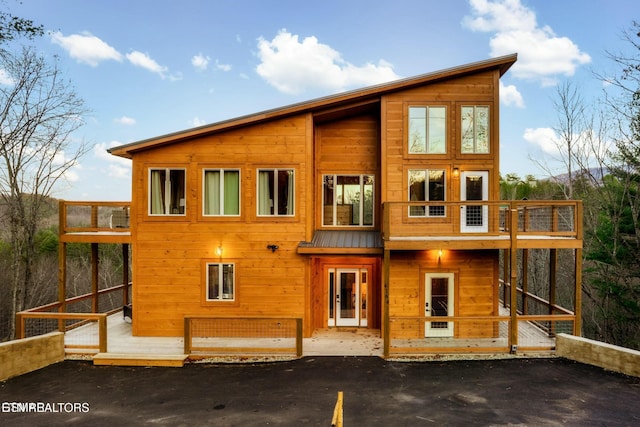 4164 Chamberlain Ln, Sevierville, TN 37862 - back of house featuring a standing seam roof, metal roof, a balcony, and a wooden deck