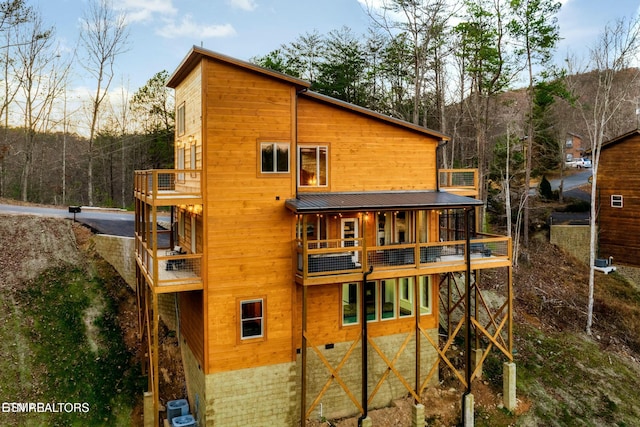 4164 Chamberlain Ln, Sevierville, TN 37862 - back of house with metal roof, central AC unit, and a balcony