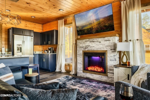 4164 Chamberlain Ln, Sevierville, TN 37862 - living area featuring wood walls, dark wood-type flooring, a stone fireplace, and wooden ceiling