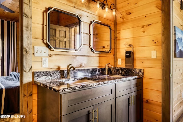 4164 Chamberlain Ln, Sevierville, TN 37862 - bathroom featuring double vanity, wooden walls, and a sink