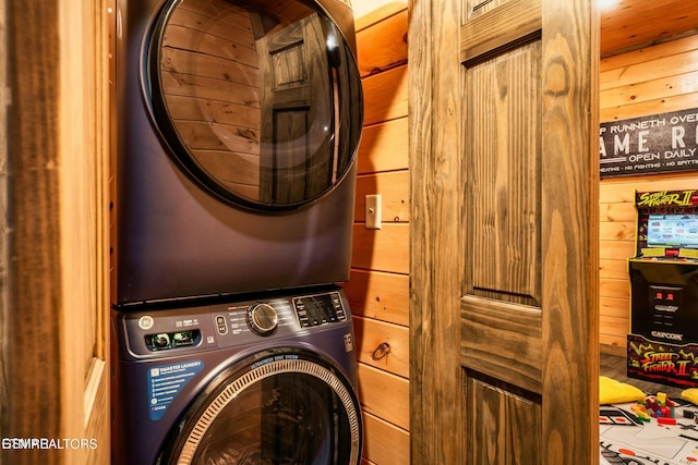 4164 Chamberlain Ln, Sevierville, TN 37862 - clothes washing area with wooden walls, stacked washer / drying machine, and laundry area