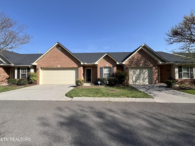 ranch-style house with a garage, a front yard, concrete driveway, and brick siding