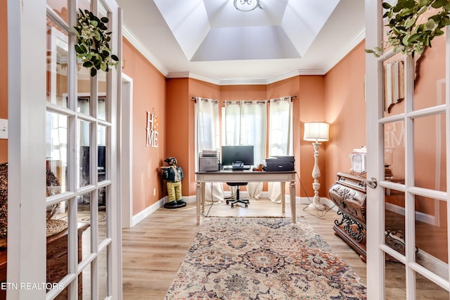 office area with light wood-style flooring, crown molding, and french doors