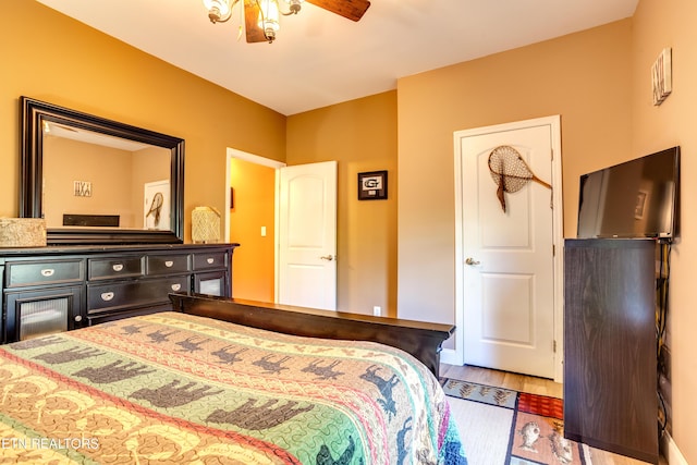 bedroom with a ceiling fan and wood finished floors