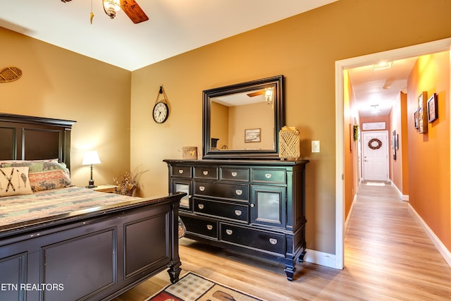 bedroom featuring light wood-style flooring and baseboards