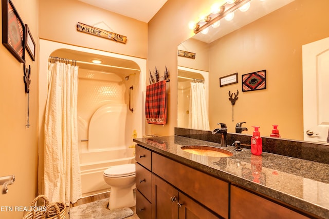 full bathroom featuring shower / bath combination with curtain, vanity, toilet, and wood finished floors
