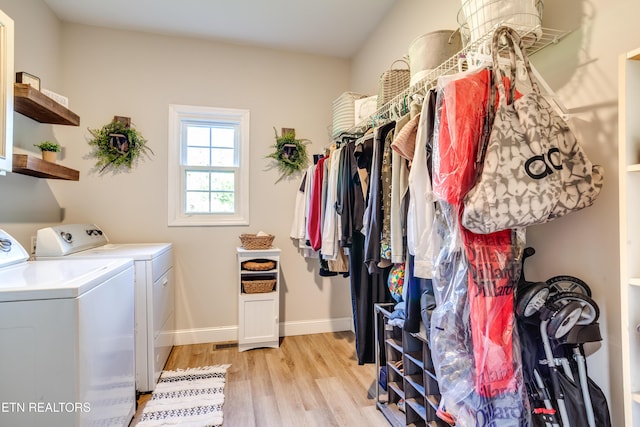 laundry room featuring washer and clothes dryer, light wood finished floors, laundry area, and baseboards