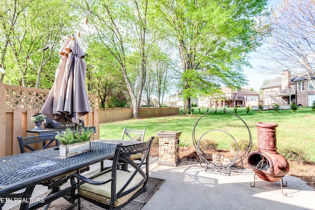 view of patio with outdoor dining space and fence