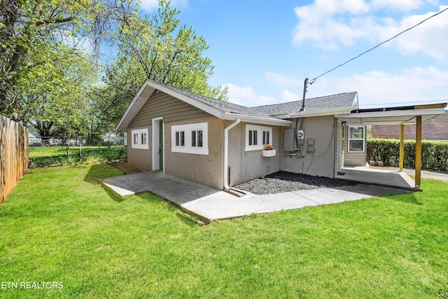 rear view of property with a patio area, a fenced backyard, a lawn, and stucco siding