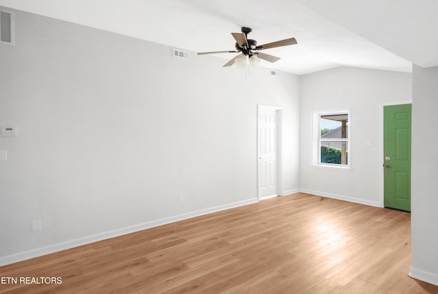 unfurnished room featuring baseboards, light wood-style flooring, a ceiling fan, visible vents, and lofted ceiling