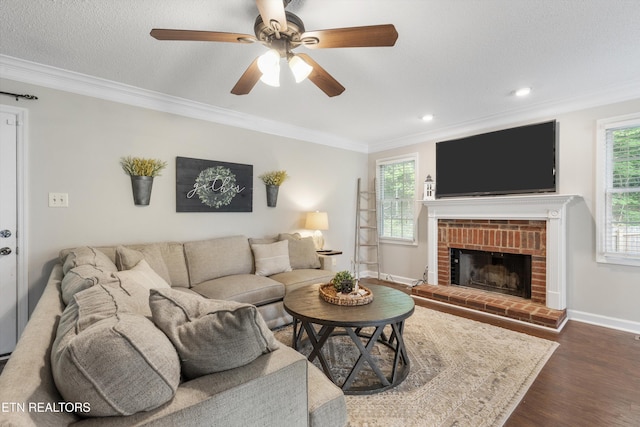 living room featuring crown molding, baseboards, recessed lighting, a ceiling fan, and dark wood finished floors