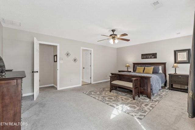carpeted bedroom featuring baseboards, ceiling fan, and visible vents