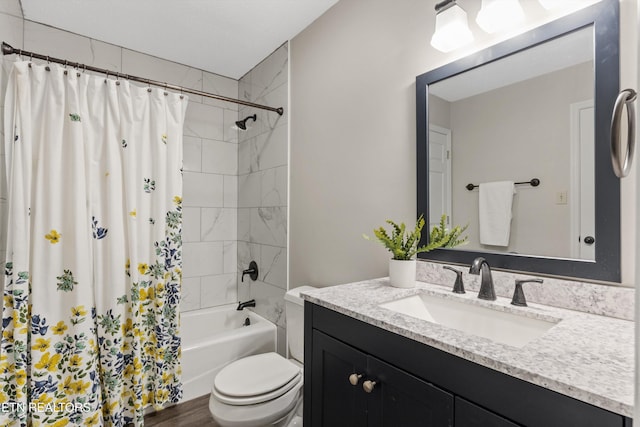 bathroom featuring vanity, shower / tub combo, and toilet