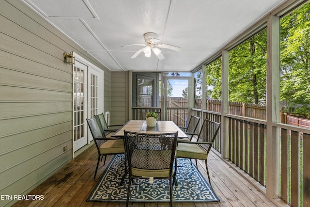 sunroom with french doors, outdoor dining area, and ceiling fan