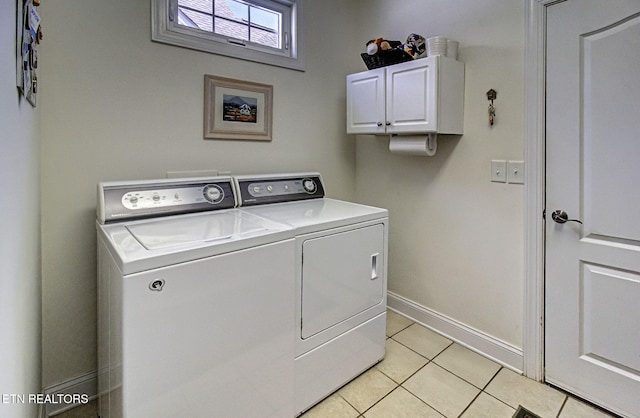 989 Rarity Bay Pkwy, Vonore, TN 37885 - clothes washing area with baseboards, washer and dryer, light tile patterned floors, and cabinet space