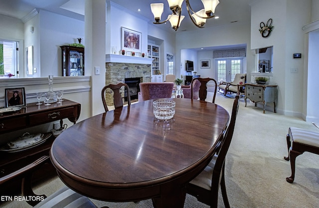 989 Rarity Bay Pkwy, Vonore, TN 37885 - dining area with a chandelier, a stone fireplace, crown molding, and carpet