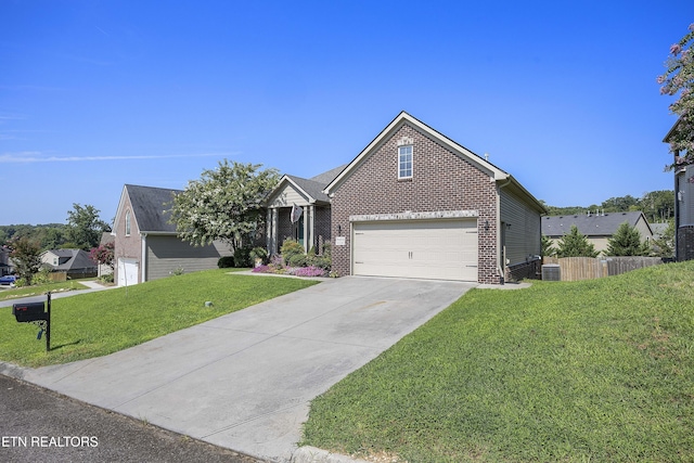 view of front facade with concrete driveway, a front yard, fence, and brick siding