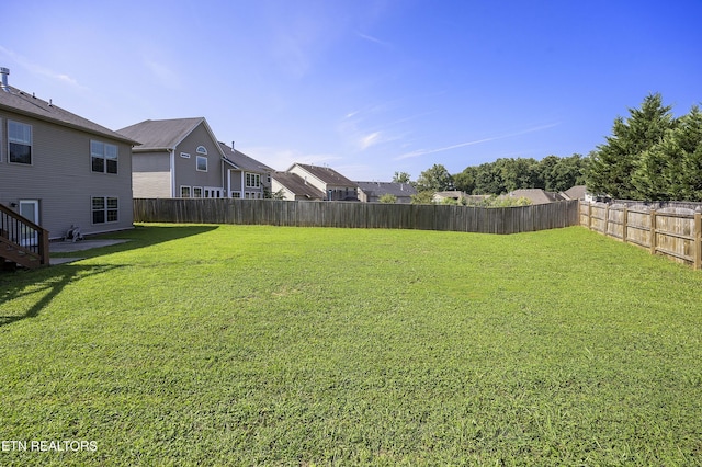 view of yard with a fenced backyard