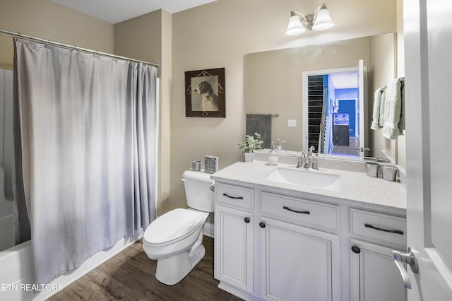 full bath featuring toilet, vanity, and wood finished floors