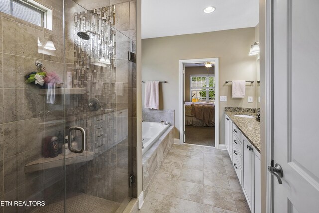 bathroom with tiled tub, connected bathroom, vanity, and a stall shower