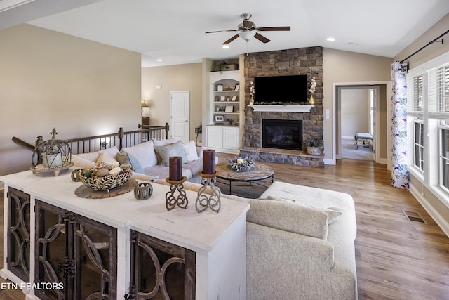 living area with a ceiling fan, vaulted ceiling, visible vents, recessed lighting, and wood finished floors