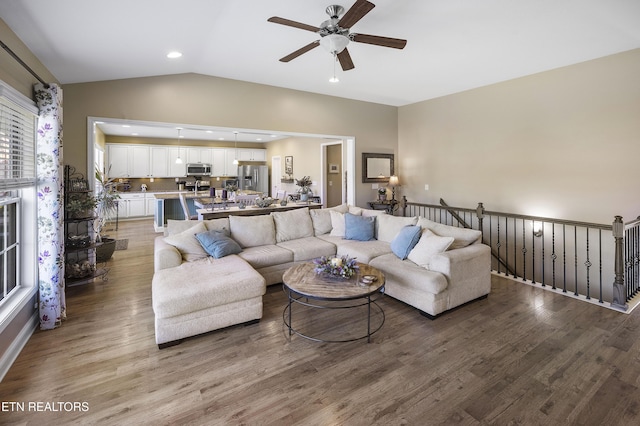 living room with wood finished floors, recessed lighting, vaulted ceiling, and ceiling fan