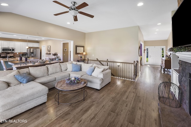 living room with dark wood-type flooring, a ceiling fan, vaulted ceiling, and recessed lighting