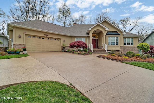 138 Stonewood Dr, Crossville, TN 38558 - view of front of home featuring brick siding, driveway, stucco siding, and an attached garage