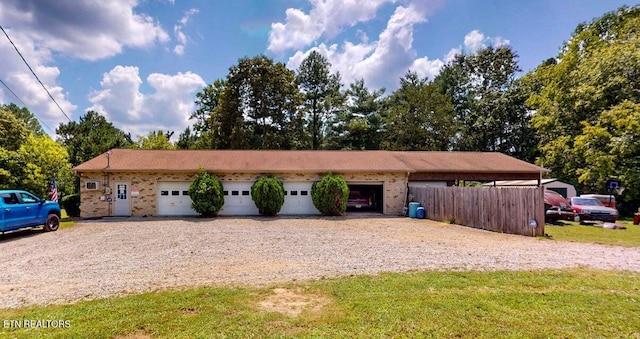 view of front facade with a garage and gravel driveway